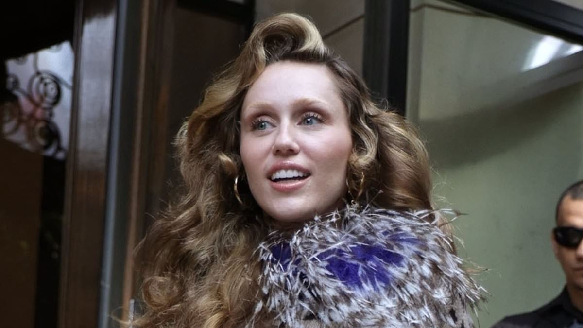 Miley Cyrus puts on a wild display in a leopard print mini dress as she cheerfully greets fans in Paris