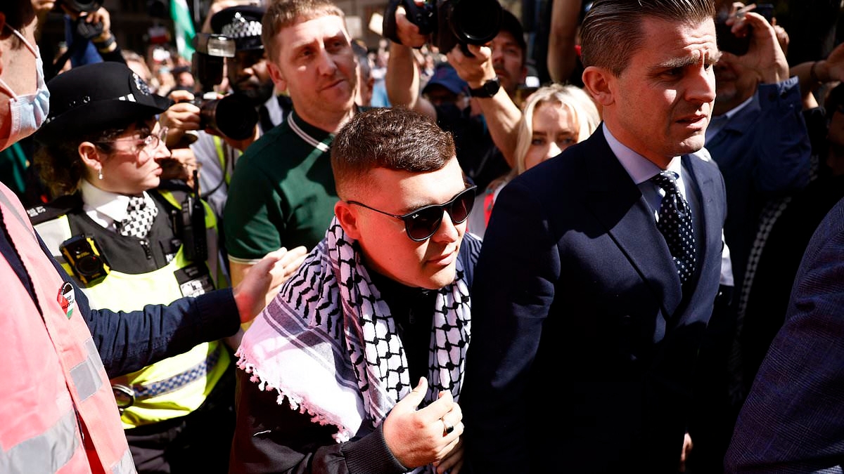 BREAKING NEWS Kneecap fans wave Palestinian flags as band member Mo Chara arrives at court after being charged with terrorism offence 'for displaying flag in support of Hezbollah'