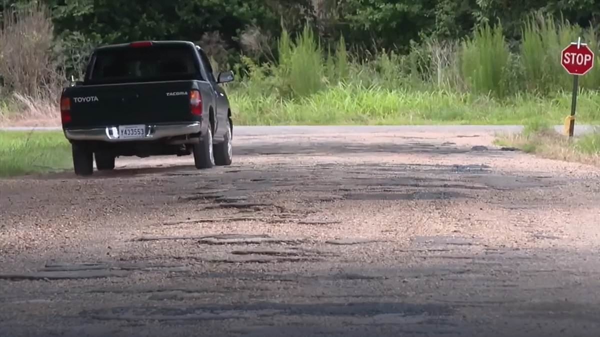 'America's worst road' has pot holes that are a FOOT deep, with mail carriers now refusing to drive down it