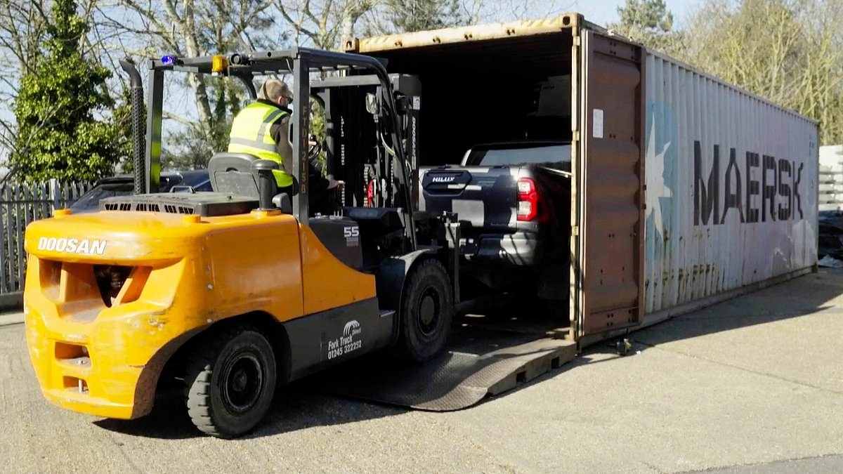 EXCLUSIVE The cars smuggled out of Britain after being stolen to order: Moment shipping container hiding three pick-up trucks is intercepted by investigators as it made its way to Africa