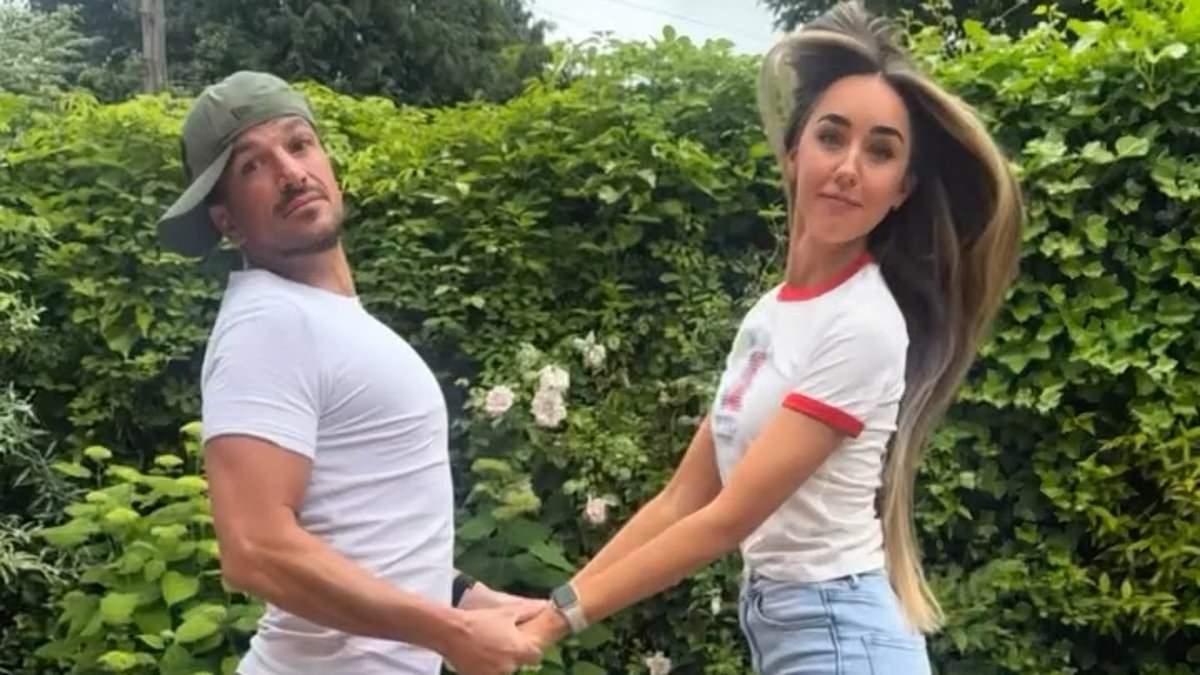 Peter Andre's wife Emily mounts him in hilarious clip as the couple practice 'awkward poses' for their 10th anniversary photoshoot
