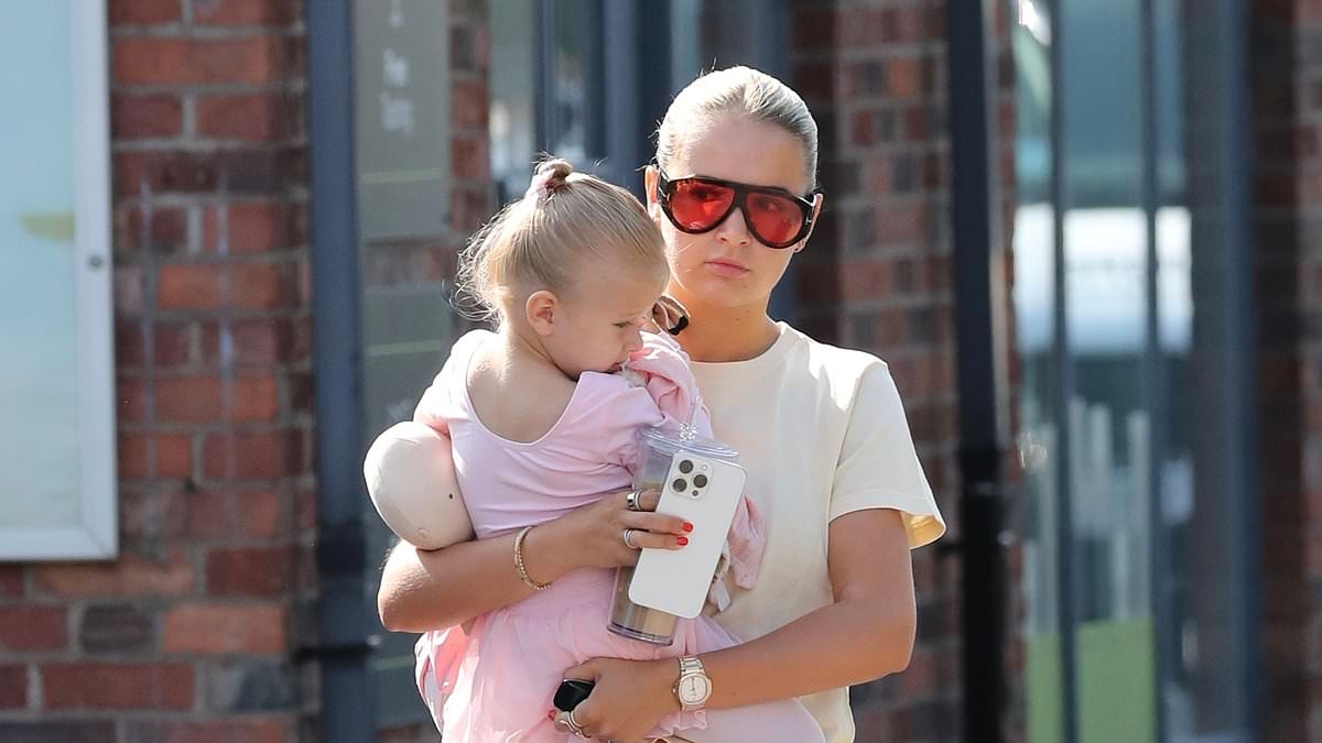 Molly-Mae Hague lovingly cradles her daughter Bambie, 2, as she takes her to a morning ballet class