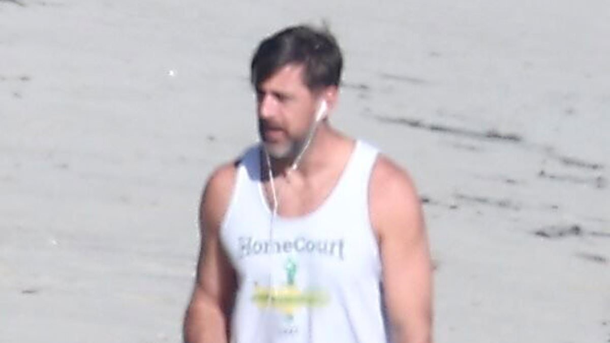 Aaron Rodgers takes lonely beach walk in Malibu as speculation swirls over his marriage to mystery woman