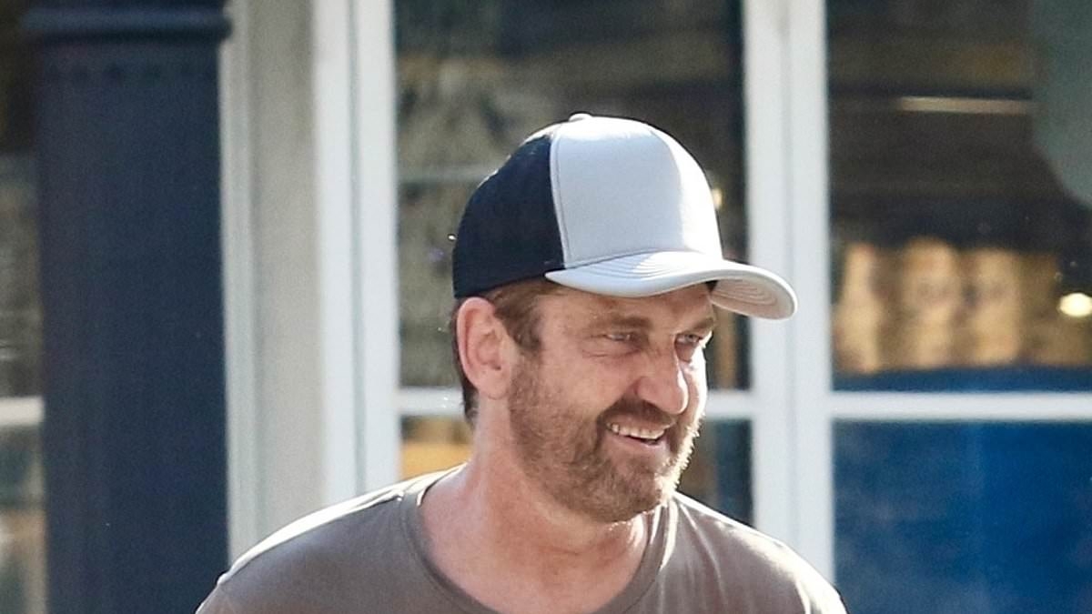 Gerard Butler looks in good spirits as he enjoys a bike ride with girlfriend Morgan Brown in NYC