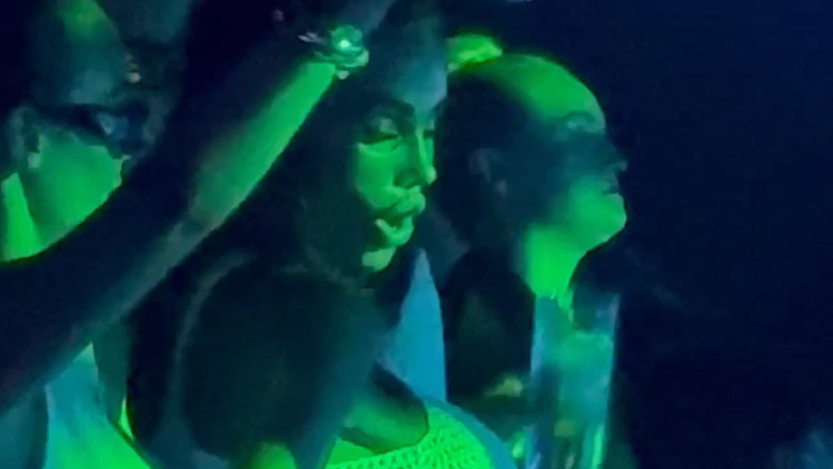 Katie Price looks worse for wear and struggles to contain her surgically-enhanced assets in a skimpy white top as she parties with Wayne Lineker in Ibiza