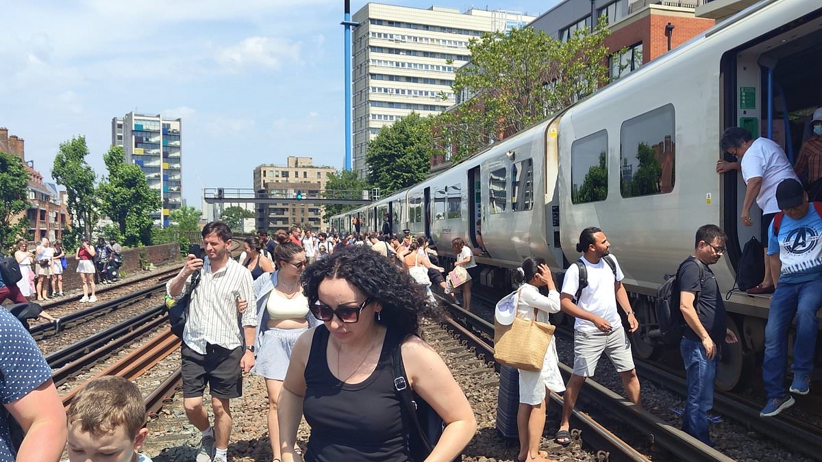 Heatwave hell as passengers are 'slow cooked' on stuck trains for hours amid 34C heat - before being forced to walk down tracks to freedom