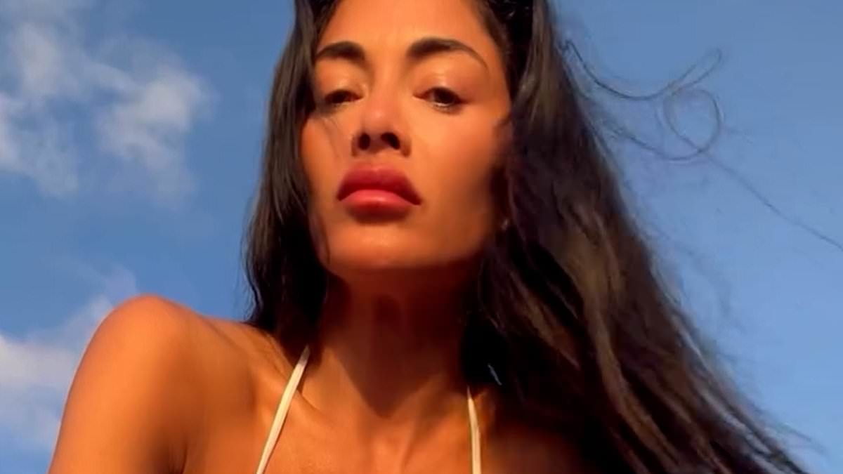 Nicole Scherzinger flaunts her jaw-dropping figure in a tiny white bikini ever as she frolics on the beach
