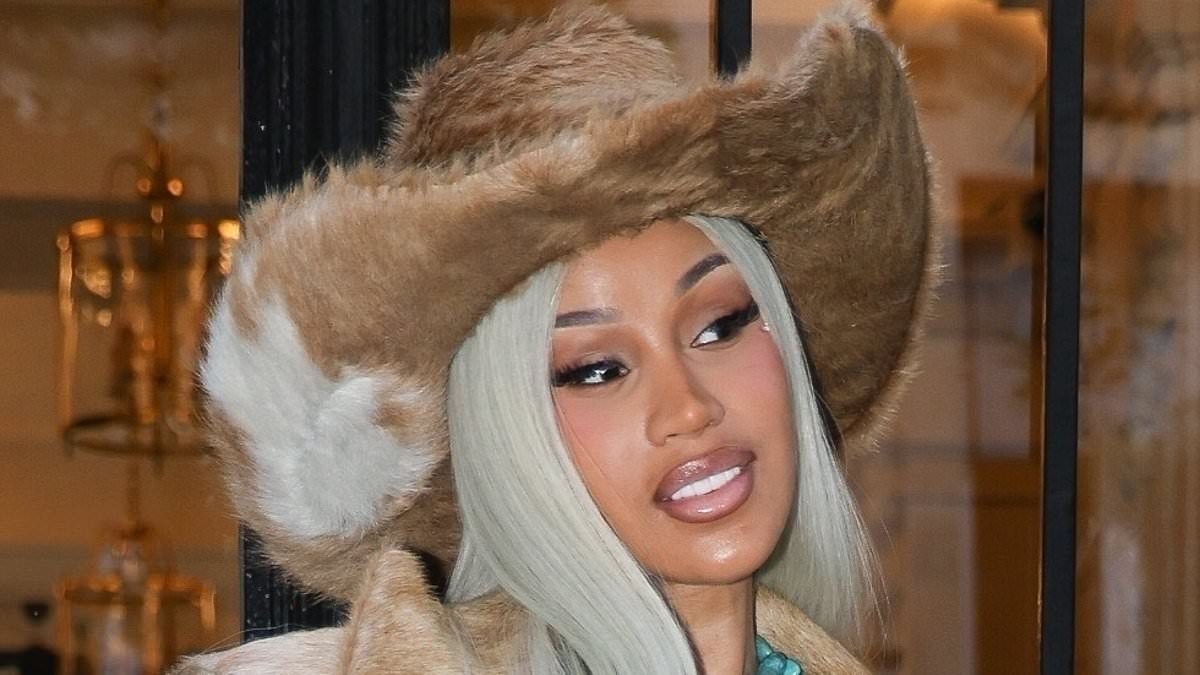 Cardi-B puts on a busty display in a bold cowboy outfit as she heads to Beyonce's concert in Paris