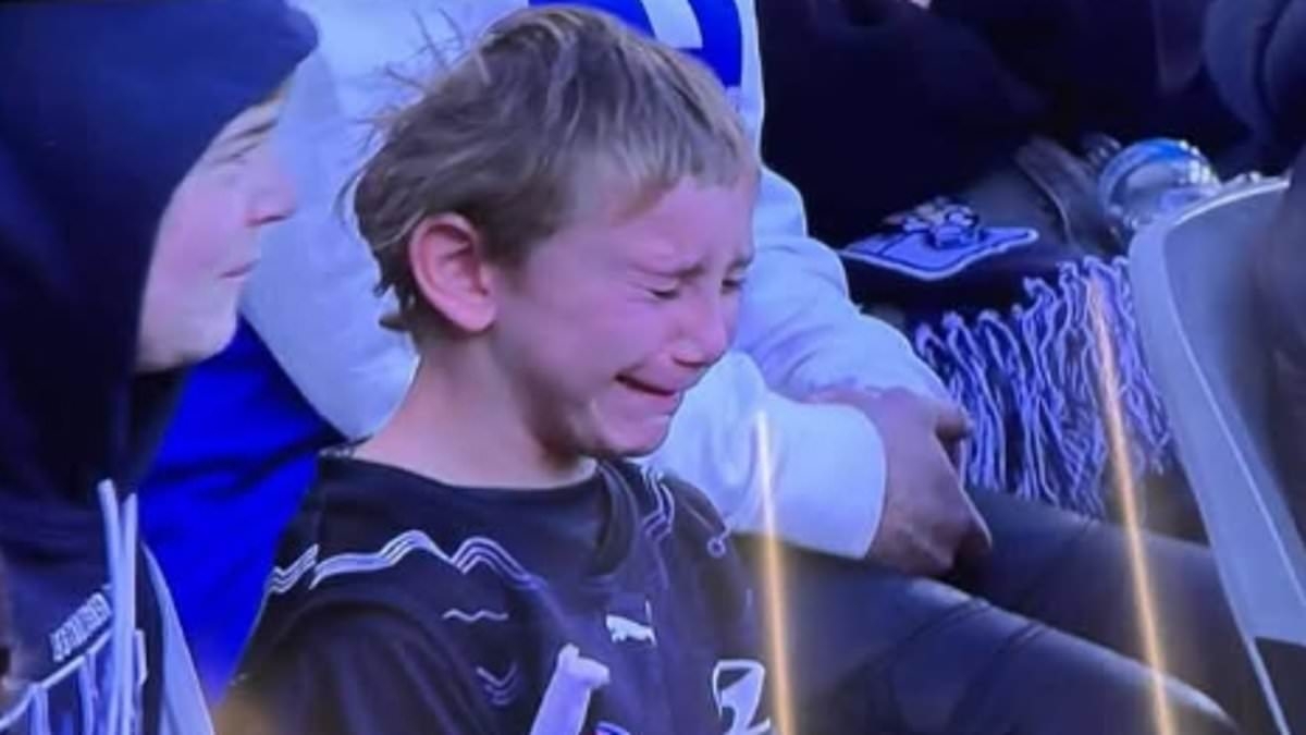 Footy fans slam TV giant for showing boy crying his eyes out at Carlton vs North Melbourne AFL match - but others say the 'snowflakes' need to 'harden up'