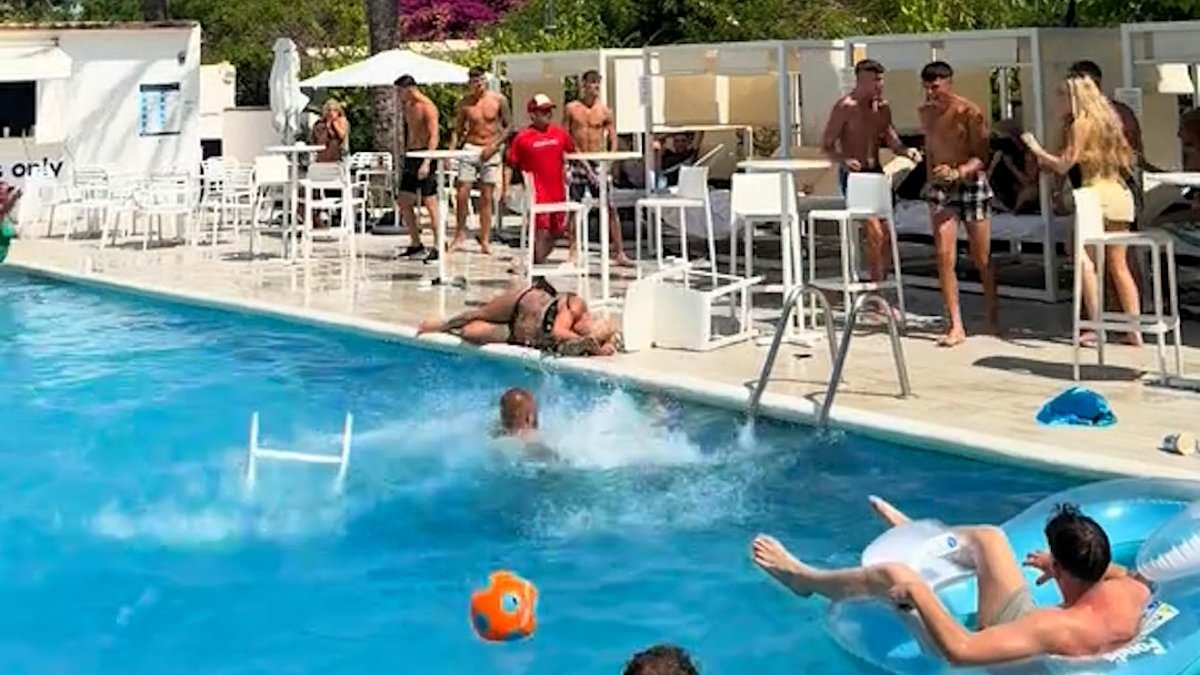 Shocking moment woman is knocked out after being hit in the head with a chair while brawl breaks out at an Ibiza hotel poolside