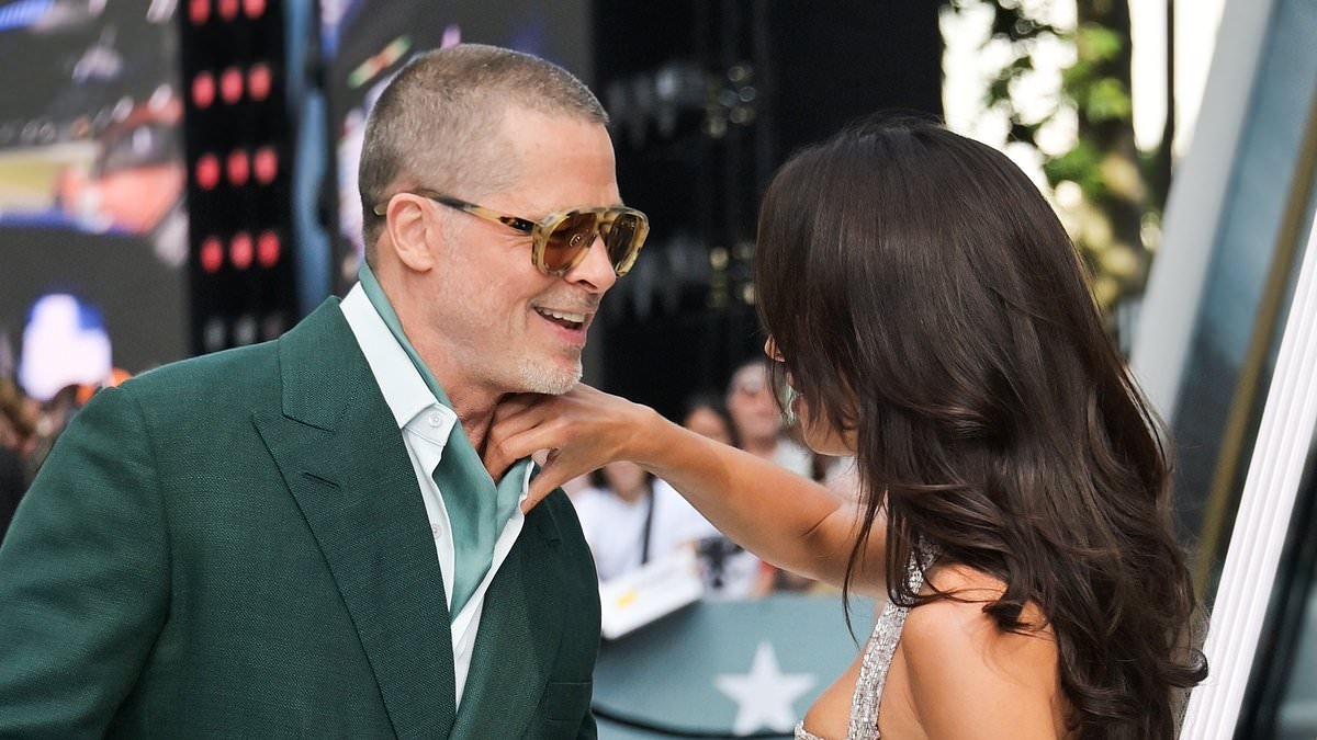 Brad Pitt looks more loved-up than ever with glamorous girlfriend Ines de Ramon as she sweetly fixes his scarf on the red carpet at F1: The Movie premiere in London