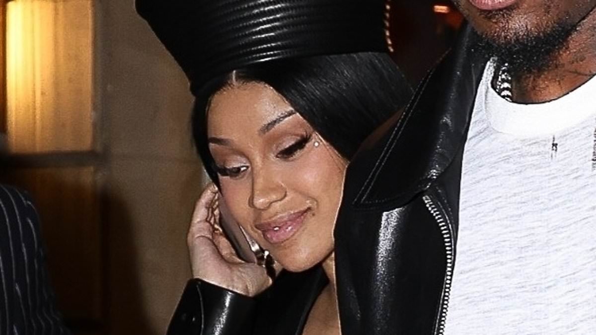 Cardi B and boyfriend Stefon Diggs hold hands as they leave Siena restaurant in Paris after romantic dinner
