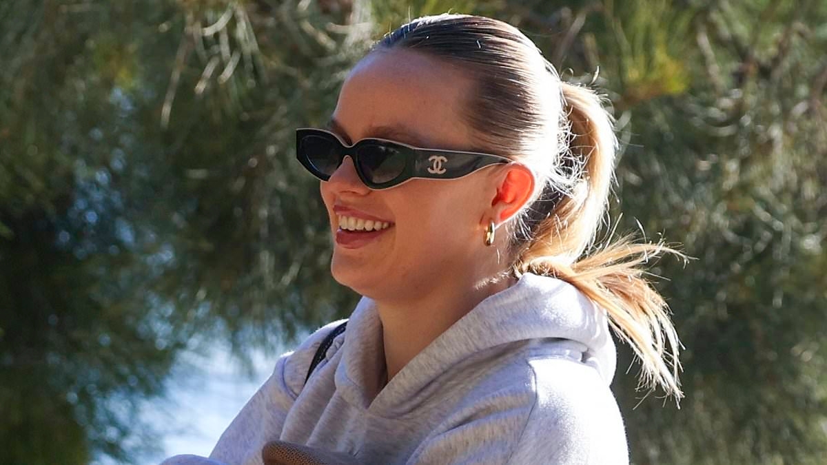 Precious cargo! Madeline Holtznagel cradles newborn baby Jaegar in a woolen jumper as she exits seaplane with billionaire Justin Hemmes