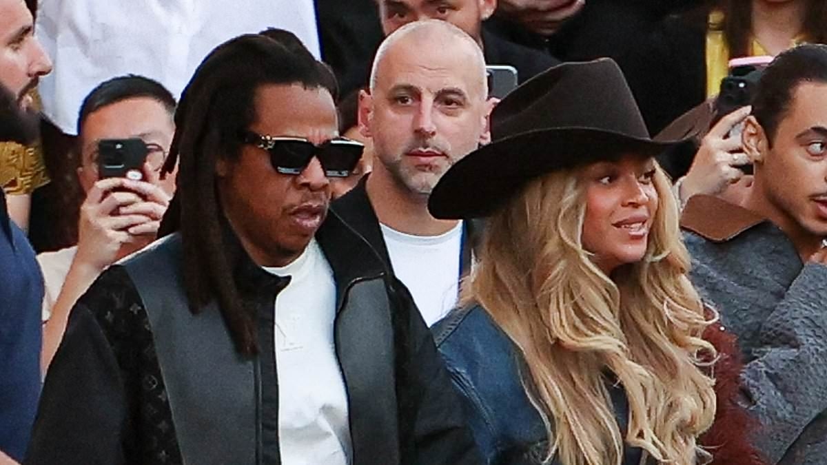 Beyoncé commands attention in double denim as she arrives hand-in-hand with husband Jay-Z to take their front row seats at Saint Laurent Menswear show during PFW
