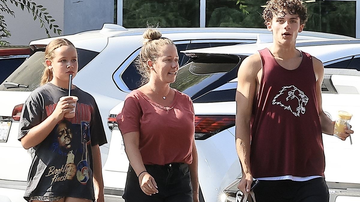 Kendra Wilkinson's son, 15, towers over her as she steps out with her two kids after turning 40