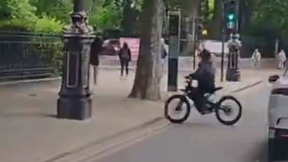 Shocking moment e-bike phone thief dangerously veers across traffic to grab mobile from stunned pedestrian victim