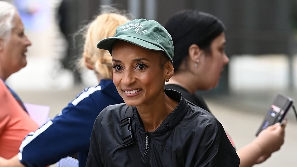 Adele Roberts cuts a cheerful figure outside Media City in Manchester after successfully completing global marathon challenge - two years after getting all-clear from bowl cancer