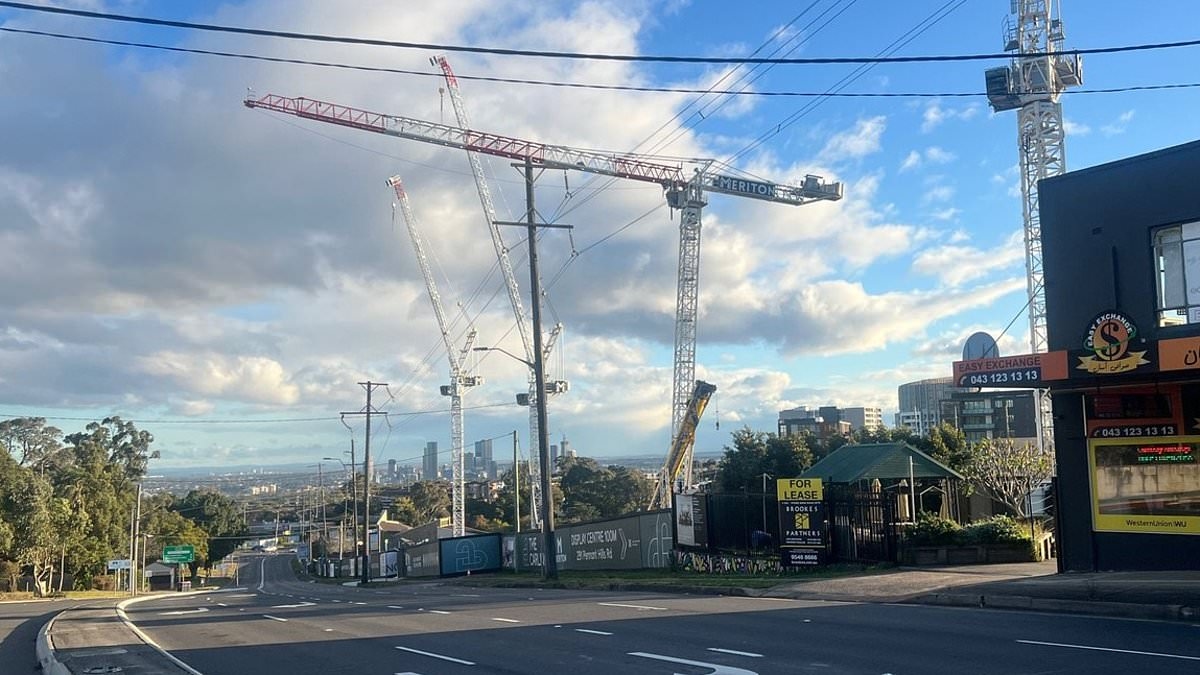 BREAKING NEWS Hundreds of lives in danger with residents evacuated and a major road shut down as crane risks tipping at any moment