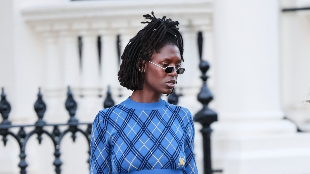 Jodie Turner-Smith flashes her abs in a Burberry crop top and midi skirt as she steps out in London with a friend