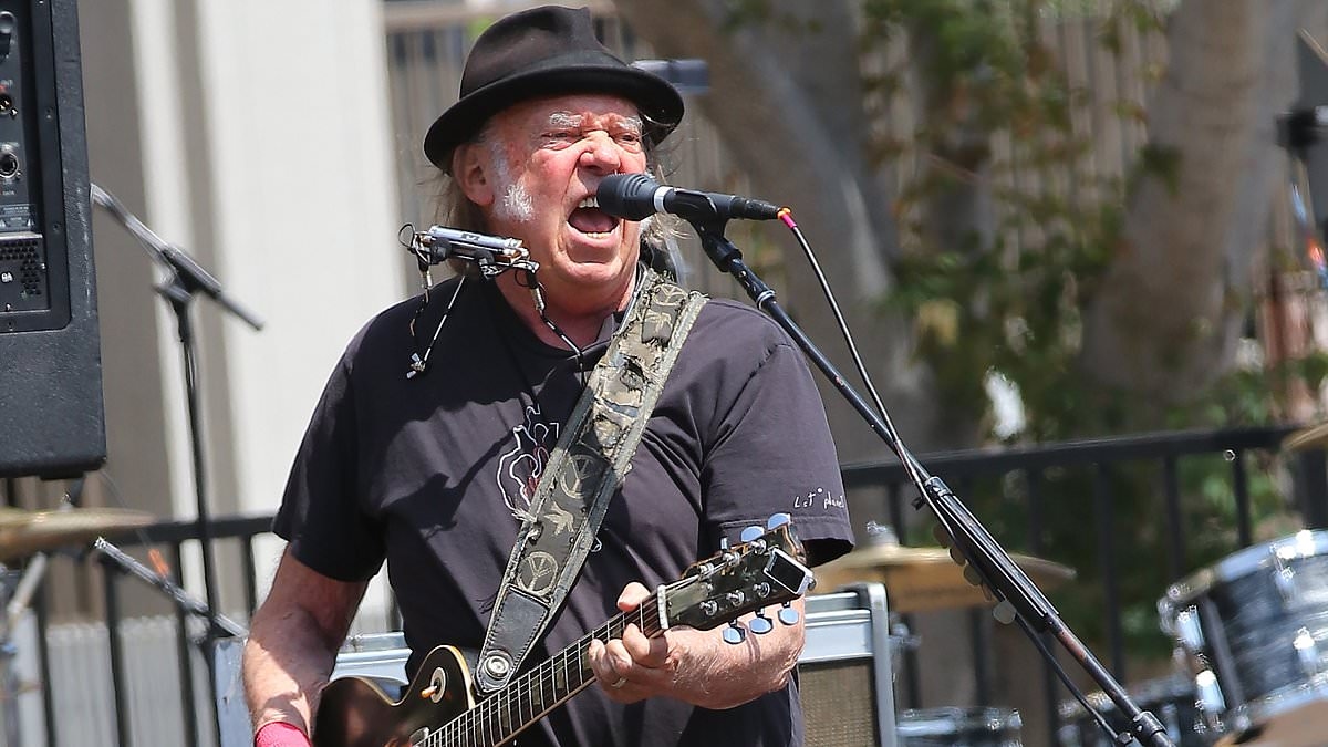 Neil Young's 'awkwardness' has gone down 'very badly' behind-the-scenes at Glastonbury, insiders tell KATIE HIND, as they reveal why his Hollywood bombshell wife Daryl Hannah is expected to skip the festival