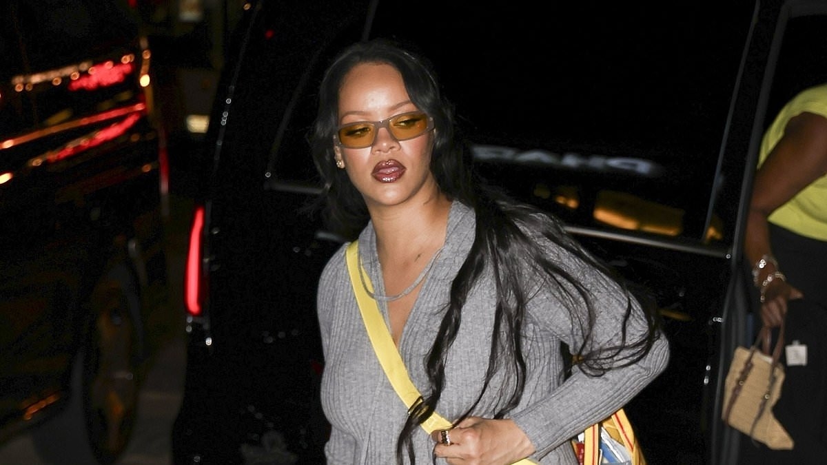 Rihanna shows off her baby bump in low slung jeans whist stepping out for family dinner in Paris after busy week in Europe