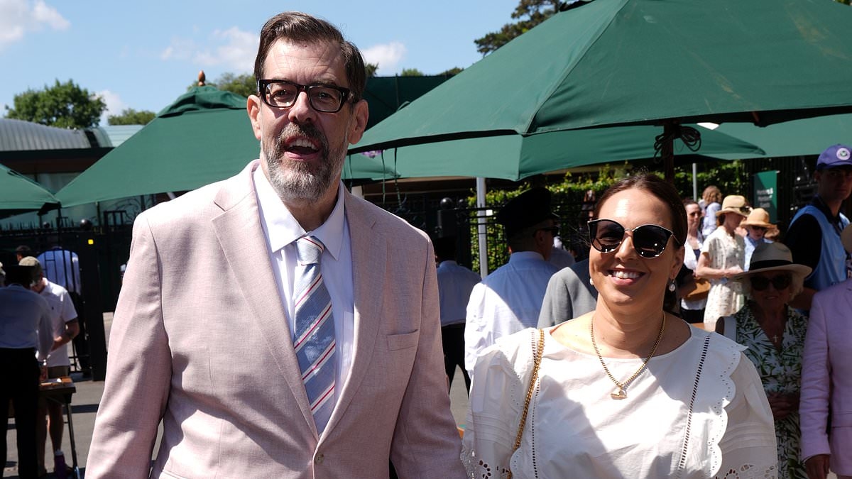 Richard Osman and his wife Ingrid Oliver hold hands as they attend the first day of Wimbledon in matching pink outfits