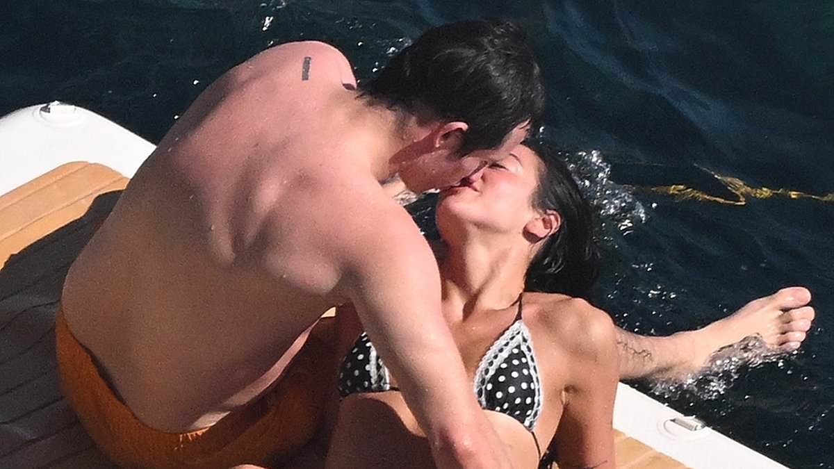Dua Lipa and fiancé Callum Turner can't keep their hands off each other as they share a passionate kiss during romantic Amalfi Coast getaway