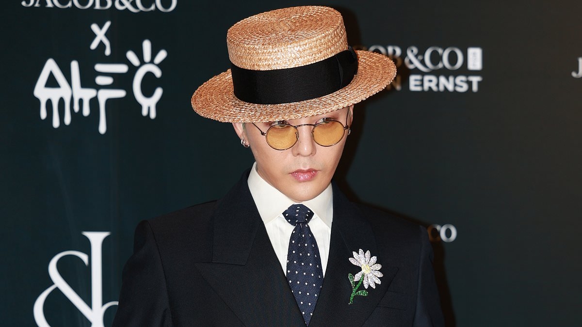 King of K-pop G-Dragon cuts a trendy figure as he arrives in Sydney flanked by heavy security fending off fans ahead of Australian leg of World Tour
