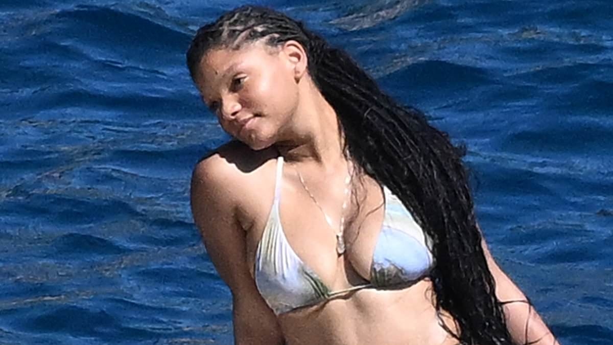 Halle Bailey nearly suffers wardrobe malfunction on romantic boat ride as her hunky mystery man is REVEALED