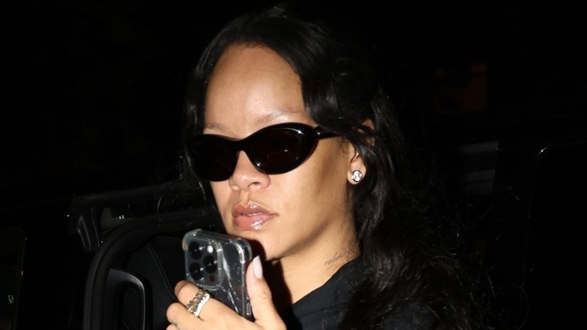 Pregnant Rihanna covers up her baby bump in a baggy black jumper as she steps out in casual ensemble in Paris