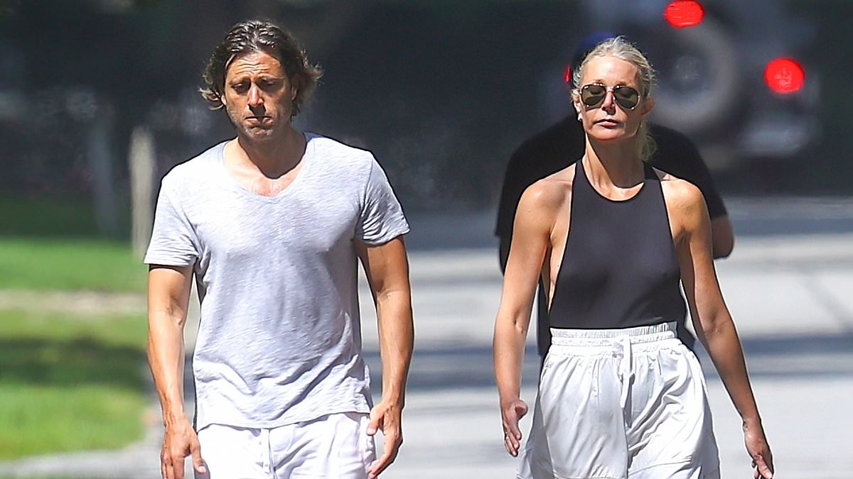Gwyneth Paltrow is bra free in a skimpy top during tense walk with husband Brad Falchuk in the Hamptons
