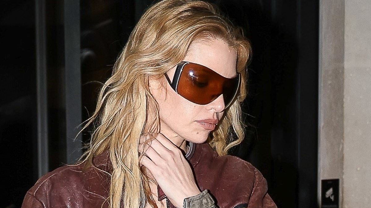 Stella Maxwell puts on a leggy display in sheer suspender tights as she steps out during haute couture fashion week in Paris