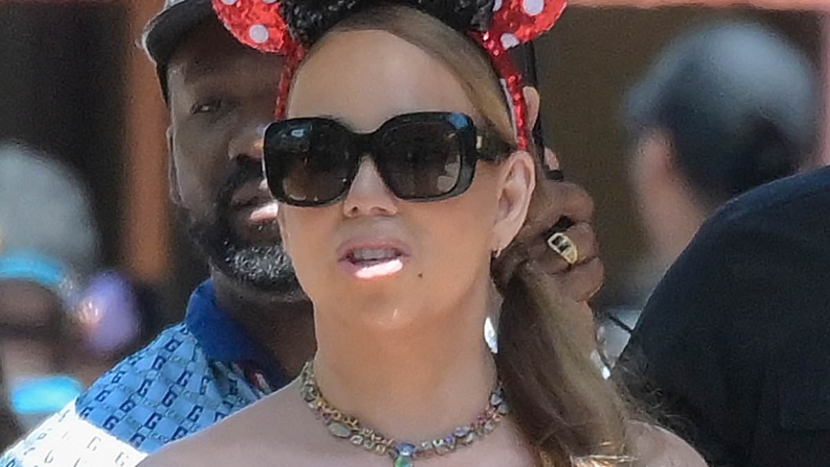 Mariah Carey, 56, continues to show off her jaw-dropping weight loss... as she hits Disneyland as the eternal diva enlists an umbrella-carrying aide to protect her from the sun