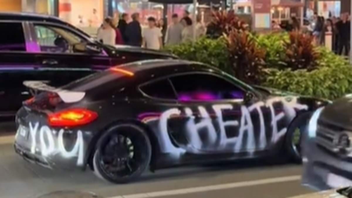 Scorned lover or a publicity stunt? $130,000 Porsche Cayman graffitied with word 'cheater' divides Aussies