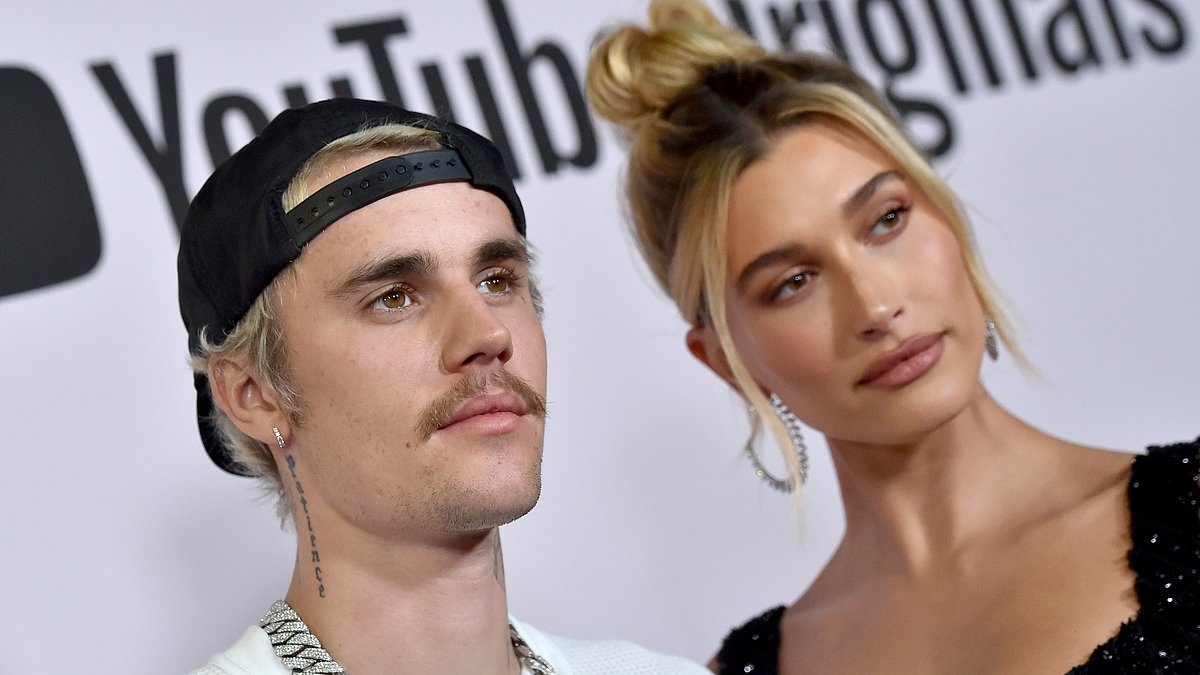 Justin Bieber awkwardly clings to wife Hailey on beach after sparking fan concern with son Jack's studio visit