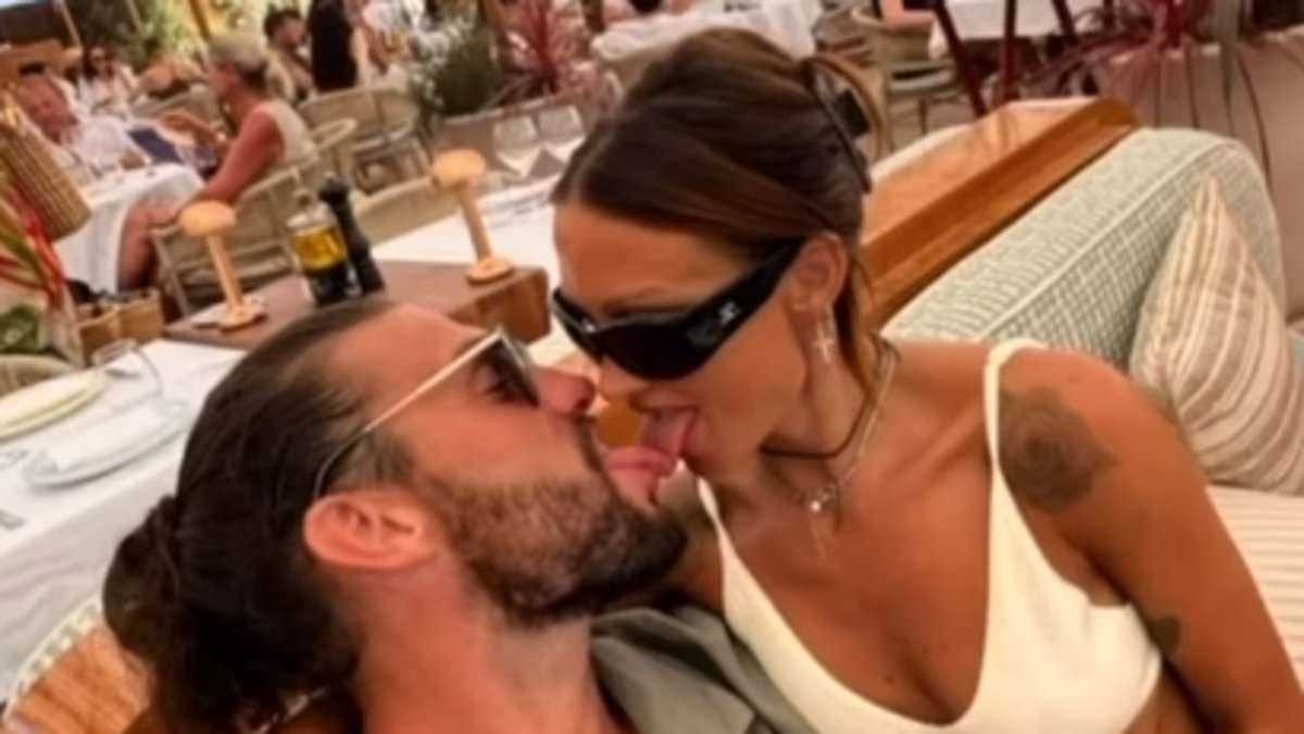 Andy Carroll, 36, LICKS girlfriend Lou Teasdale, 41, as the couple pack on the PDA in holiday snaps after 'Greek police were called over bust-up'