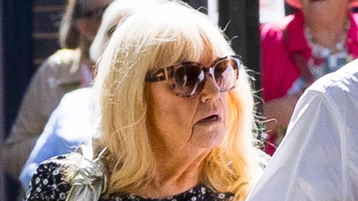 Slimline Judy Finnigan, 77, and her husband Richard Madeley, 69, look loved-up as they go arm in arm on walk - after he revealed painful injury