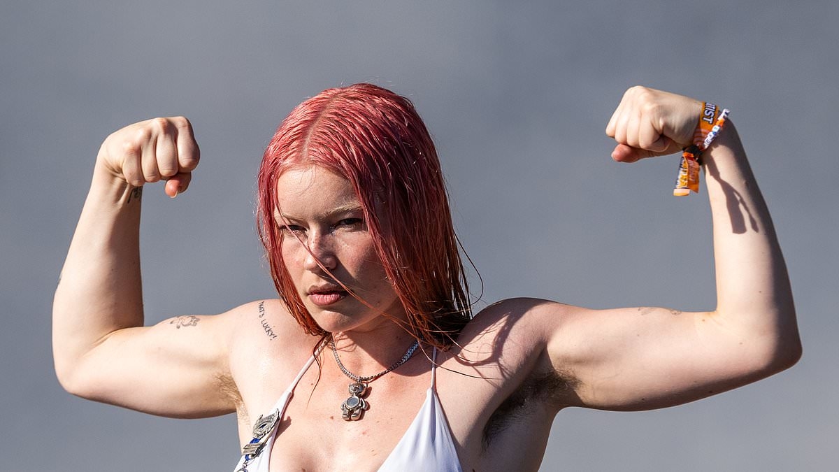 Wet Leg's Rhian Teasdale shows off her sculpted physique in a bikini top and hot pants as she takes to the stage at Scotland's TRNSMT Festival