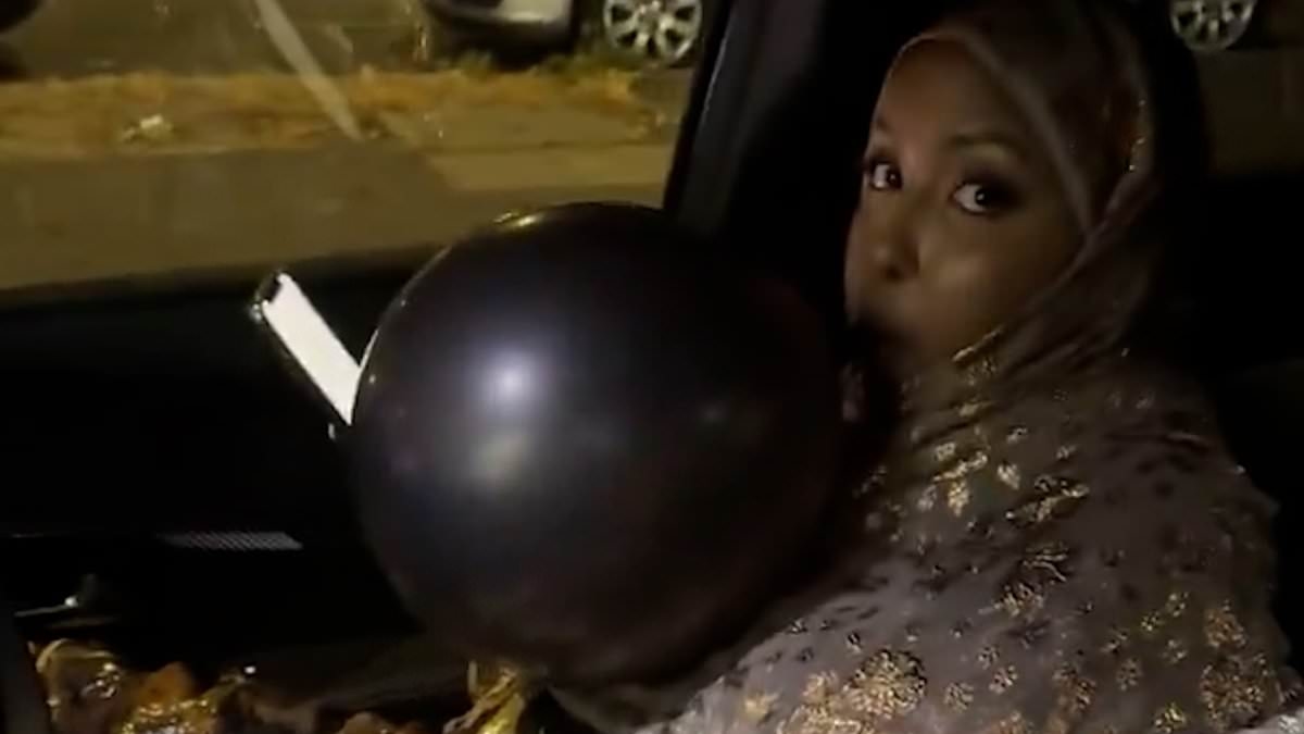 Moment brazen woman is confronted by passerby as she huffs from a balloon in parked car whilst surrounded by gas canisters