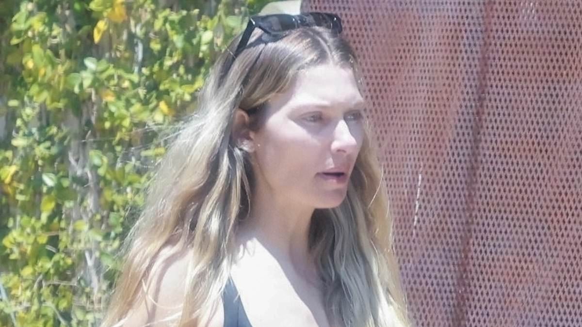 Model Jessica Hart looks glum as she packs her belongings into a storage unit - after ugly split from her race car driver fiancé James Kirkham