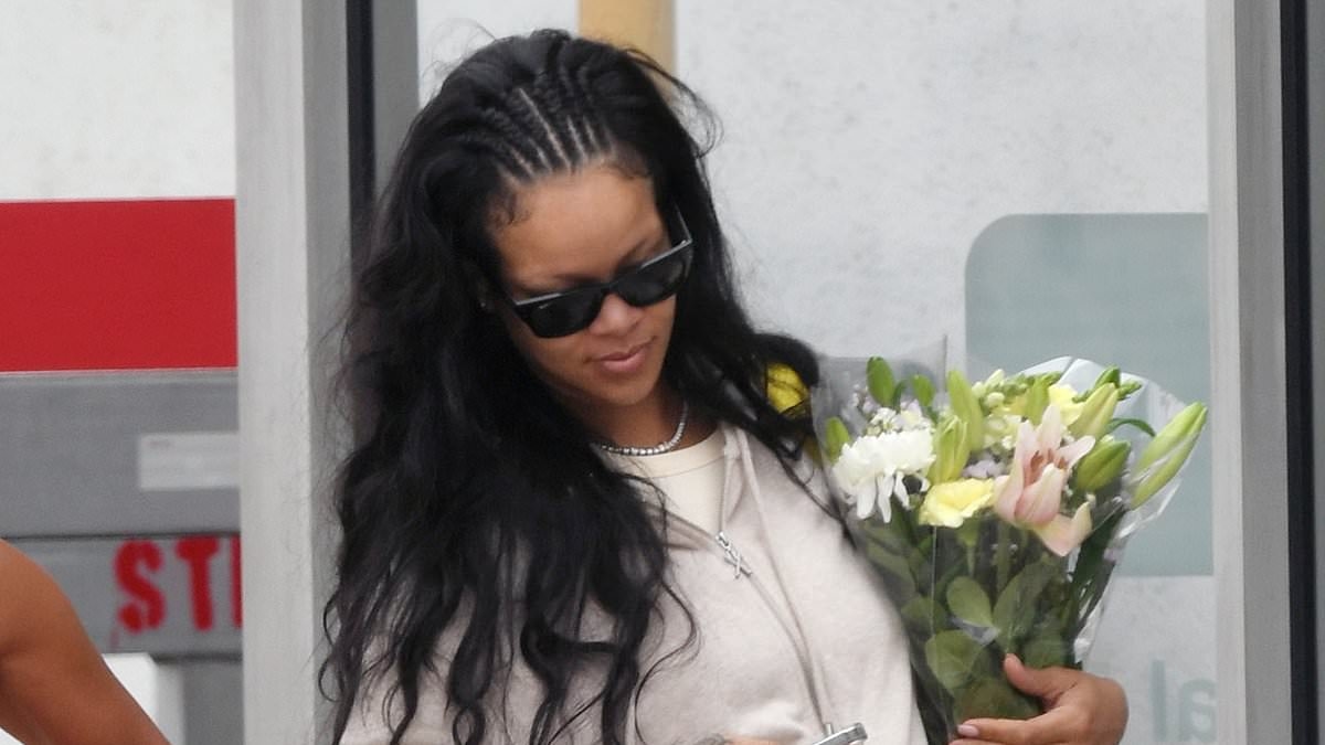 Rihanna holds a bouquet as she arrives in LA after her dad Ronald's funeral