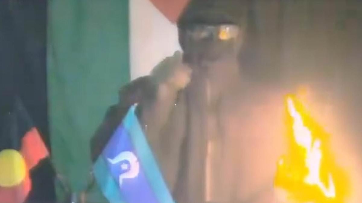 BREAKING NEWS Disturbing bombing threat is issued on video by masked man standing with Aboriginal and Torres Strait Islander flags: 'Every colony will burn'