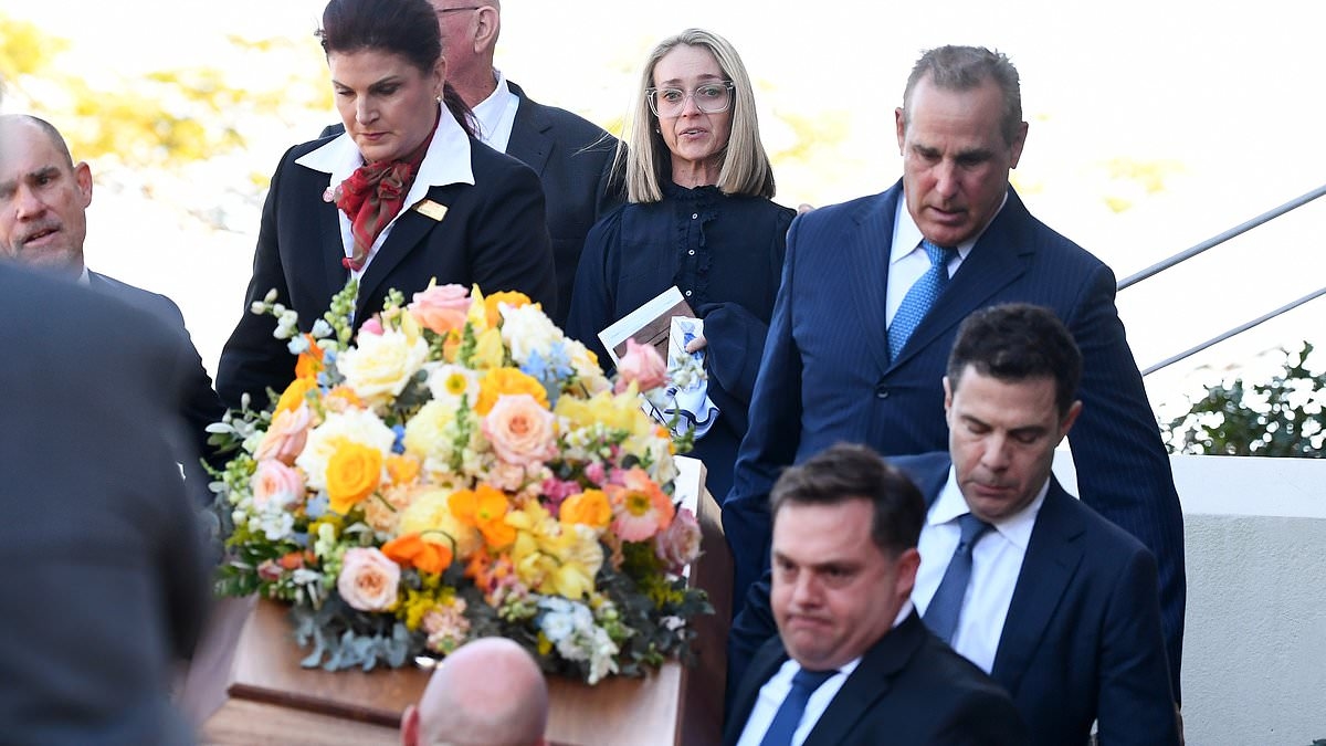 Shattered widow of Universal Store CEO who was allegedly stabbed to death by a 15-year-old boy is comforted by loved ones as she pays her final respects at funeral