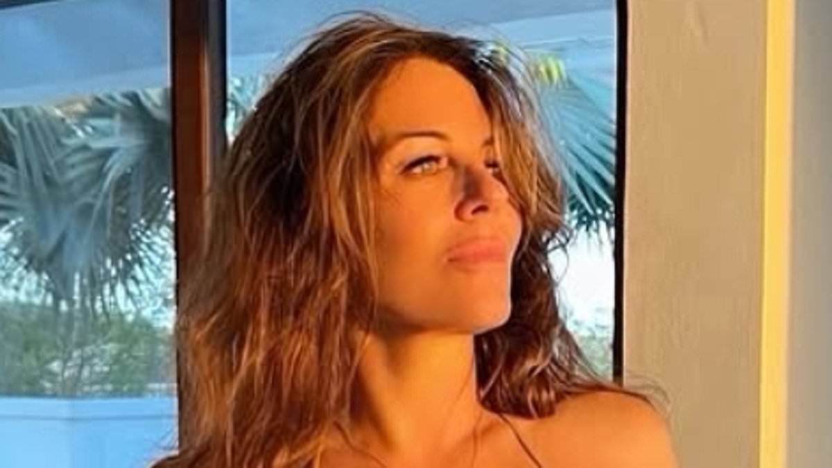 Bikini-clad Elizabeth Hurley, 60, shows off her jaw-dropping figure in skimpy gold swimwear as she reveals the 'secret to capturing a flattering bikini snap'