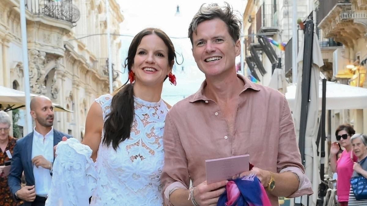 Sting's daughter Fuchsia Kate Sumner is a vision in a bridal lace gown as she kisses her groom during extravagant pre-wedding street bash with Italian marching band in Sicily
