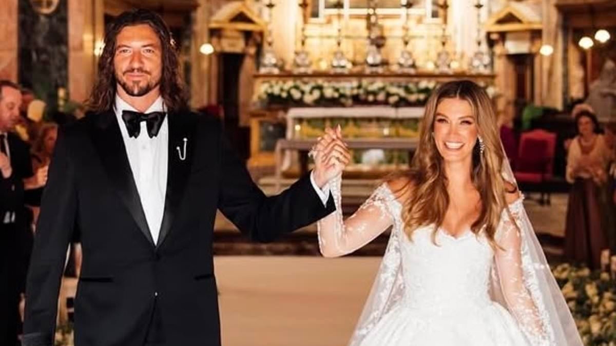 Inside Delta Goodrem's wild wedding reception as she shows off dazzling second dress… and rocks out to surprise entrance song with husband Matthew Copley