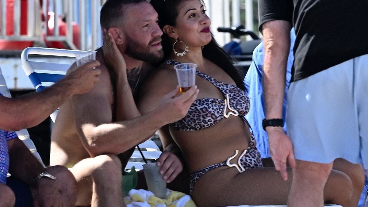 Conor McGregor is spotted with mystery woman he was caught kissing AGAIN at cosy birthday dinner - after 'liking' post condemning his antics