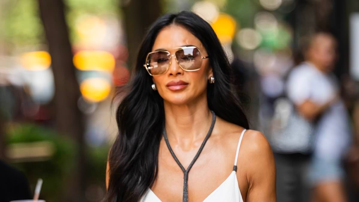Nicole Scherzinger is the epitome of chic in a plunging white maxi dress and shades as she steps out in NYC