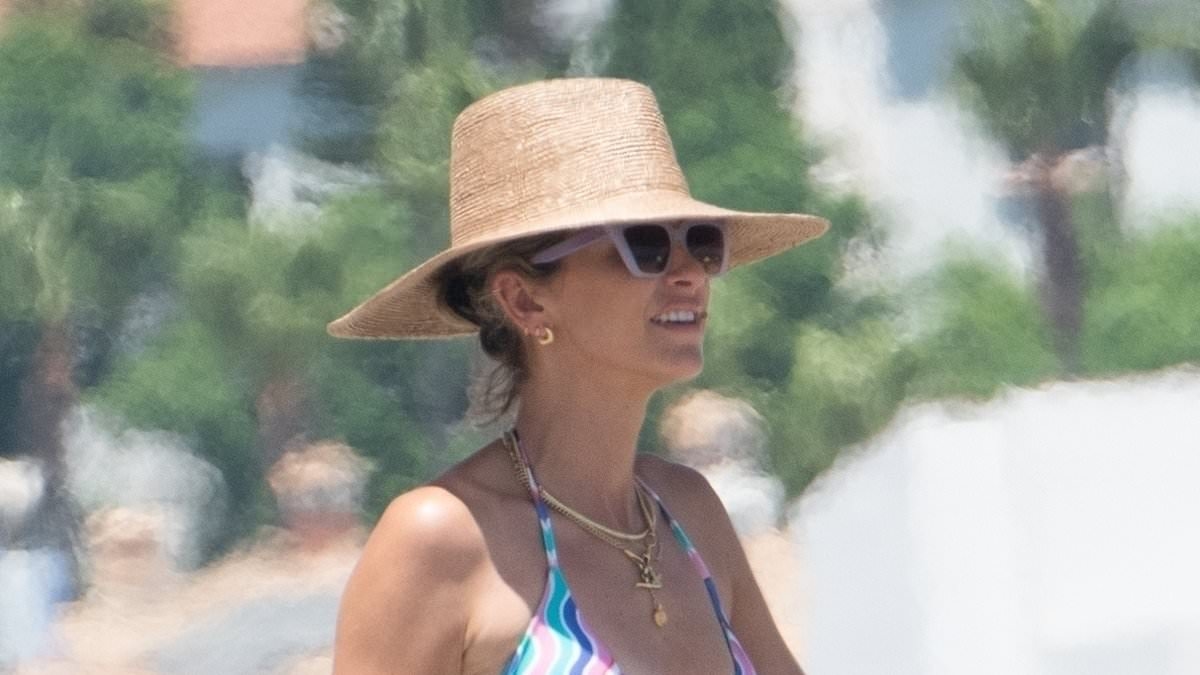 Vogue Williams flaunts her toned figure in tiny patterned bikini as she enjoys sun-soaked beach day with chiselled husband Spencer Matthews during family getaway in Spain