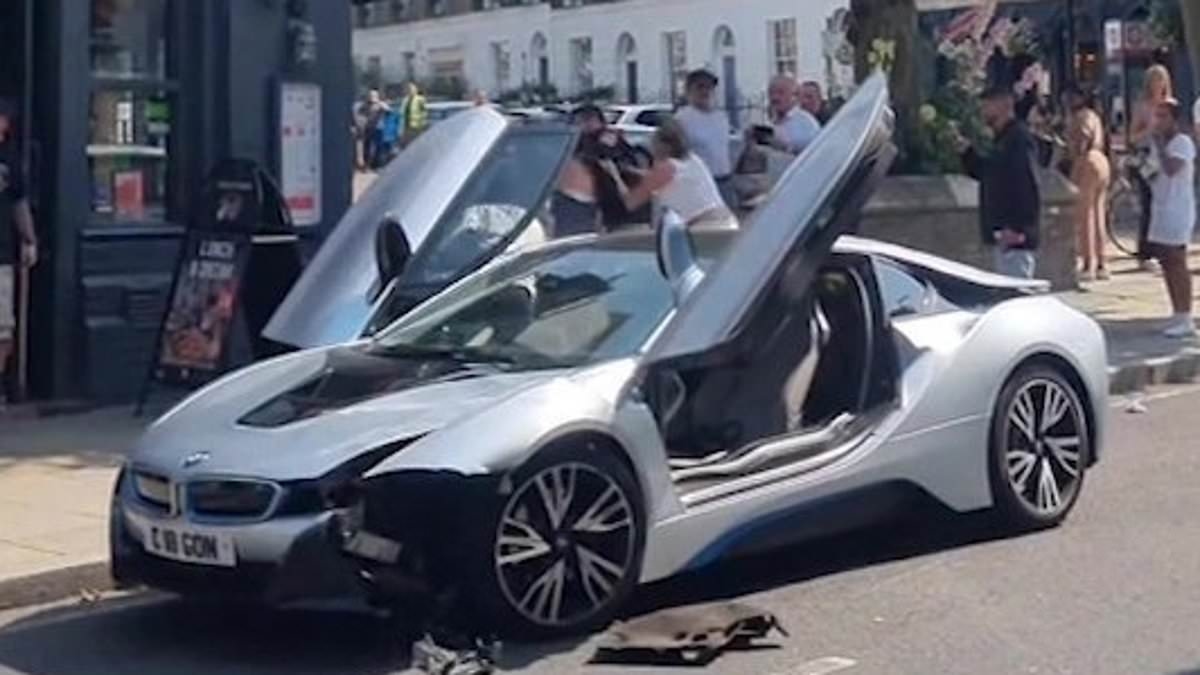 Moment reckless driver sparks street brawl after crashing her £106,000 BMW i8 into parked car on busy London street